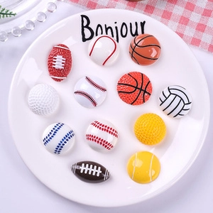 Macro detail of assorted resin sports ball charms like basketball and soccer balls