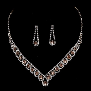 Macro shot of silver bridal necklace and earrings set with champagne rhinestones