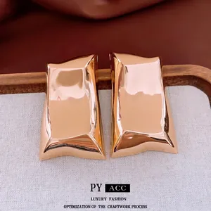 Polished gold irregular geometric earrings with a modern liquid metal mirror finish