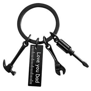 Detail of matte black Dad tool keychain with hammer wrench screwdriver and engraved tag