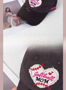 Detail of distressed baseball cap with heart patch, pink softball mom embroidery and ripped brim