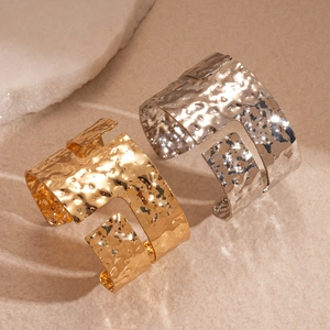 Irregular hammered metal cuffs in gold and silver with stylish H hollow design