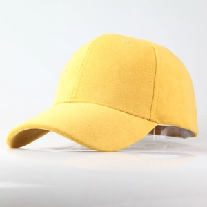 Detailed view of the yellow faux suede texture and stitching on a classic baseball cap