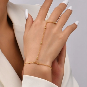 Detailed view of elegant gold star and butterfly finger bracelet chain worn on hand