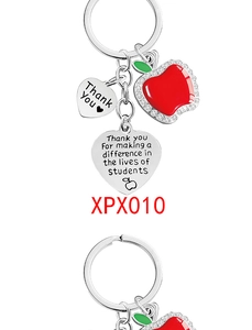 Detail of teacher appreciation keychain with red apple pendant and thank you engravings
