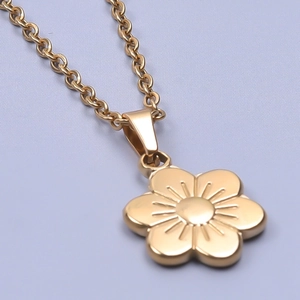 Detail of 18k gold plated floral pendant with five petals on a chunky chain necklace