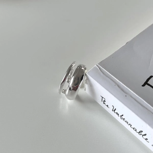 Detail of minimalist S925 silver double-layered ring with high-polished texture