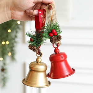 Festive red and gold Christmas bell ornaments with pine cones and berries decoration