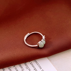 Detailed close-up of double green gourd gemstones on a silver adjustable ring