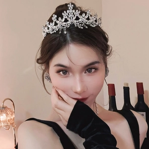 Detail of silver floral crown headband with tassels and rhinestones on hair