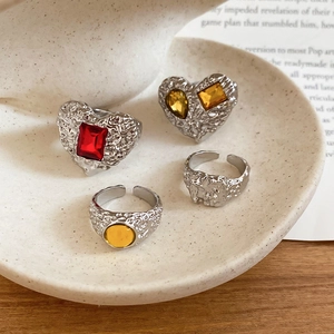 Detailed set of four vintage resin heart rings with lava texture and colorful gemstones