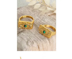 Detailed close-up of vintage gold evil eye ring with green malachite stone and white zircon