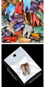 Macro shot of natural crystal tooth pendants with gold metal bails and packaging details