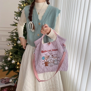 Purple quilted puffer tote bag with cute dog illustrations and adjustable strap