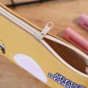 Detailed macro view of yellow PU leather pencil case texture and smooth metal zipper