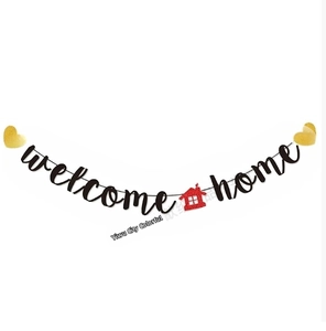 Detail view of Welcome Home banner with golden hearts and a glittery red house icon