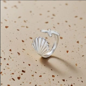 Adjustable silver titanium steel open ring featuring detailed seashell and starfish designs