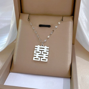 Macro view of silver titanium steel necklace with traditional Double Happiness pendant