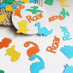 Colorful dinosaur confetti with Roar letters for themed birthday party decorations