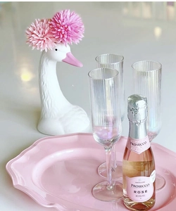 Pink wavy decorative tray with elegant swan ceramic vase and realistic floral decor