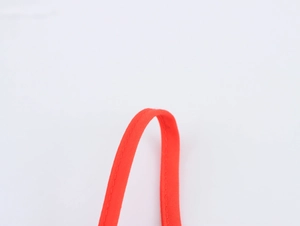 Detail of red fabric shoulder strap with neat stitching on sweet vacation style dress