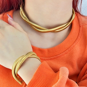 18K gold plated twisted snake chain necklace and bangle set worn by a female model