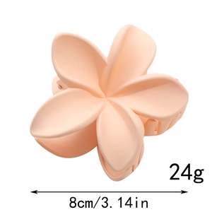 Détail de la pince à cheveux fleur de 8 cm en abricot mat avec poids de 24 g