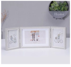 Detail of grey wood grain triple folding picture frame with decorative holiday art cards