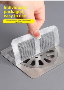 Close-up of disposable mesh drain sticker filtering hair on bathroom metal floor drain