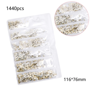 Macro view of 1440pcs flatback crystal glass nail rhinestones in a multi-grid pack