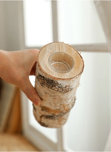 Detail of natural birch wood candle holder with integrated glass container for home decor