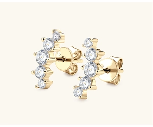 Close-up of golden curved earrings with five graduated sparkling crystals and butterfly backs