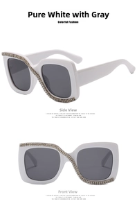 Detail view of square white sunglasses featuring sparkling rhinestone diagonal embellishments
