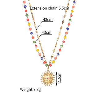Detail shot of 18K gold stainless steel layered necklace with colorful beads and flower