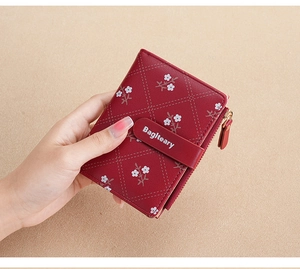 Close-up of red PU leather wallet featuring white floral patterns and quilted diamond texture