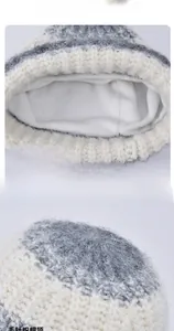 Detail showing soft white plush lining and knitted texture of the pink winter hat