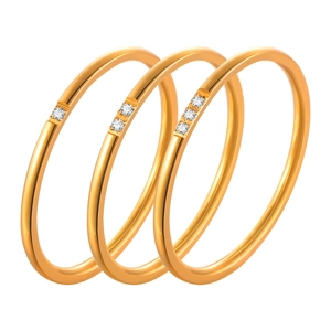 Three-piece gold-plated stainless steel ring set with zircon accents on white background