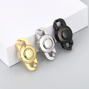 Polished stainless steel chain clasps in gold silver and black on a white stand