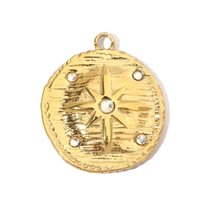 Detailed close-up of gold plated round star charm with rhinestones and textured surface