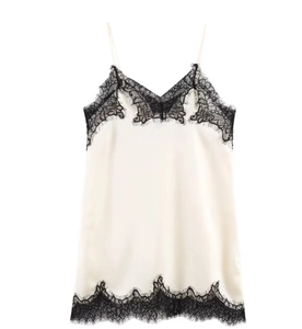 Close-up of white satin camisole with black eyelash lace trim and delicate V-neck detail