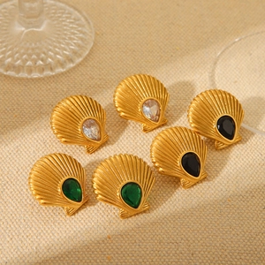 Detailed view of gold shell earrings with white black and green zircon inlays