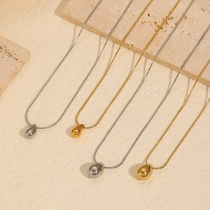 Minimalist gold and silver teardrop pendants on sleek snake chains in stainless steel