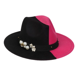Detail of felt fedora hat featuring black and red patchwork with pearls and metal floral trim