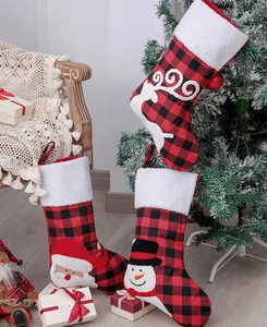 Close-up of red and black buffalo plaid Christmas stockings with 3D festive characters