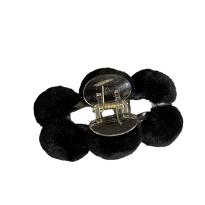 Cute black plush ball hair claw clip with transparent plastic and metal spring detail
