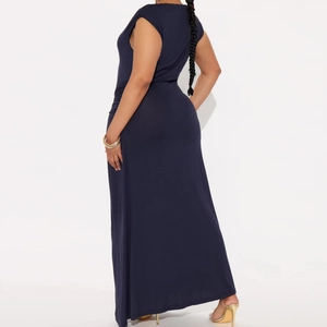 Detail of navy blue maxi dress featuring elegant side ruching and draped fabric silhouette