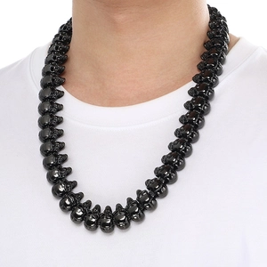 Macro shot of black gothic skull necklace pendant with high-contrast punk rock details