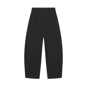 Detailed view of high-waist pleated black balloon pants featuring premium woven fabric