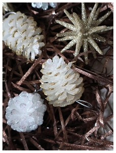 Macro view of white glitter pine cones and gold star ornaments for Christmas trees