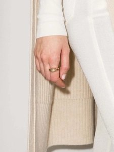 Close-up of minimalist gold-plated stainless steel ring with a polished arc design